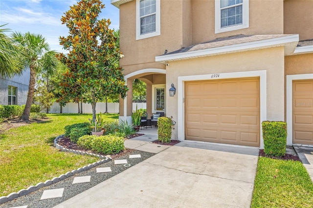 6974 Holly Heath Dr, Riverview, FL 33578 - view of front of house featuring stucco siding, driveway, and a garage