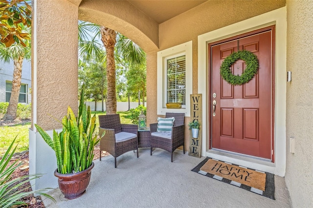 6974 Holly Heath Dr, Riverview, FL 33578 - view of exterior entry featuring stucco siding and a porch