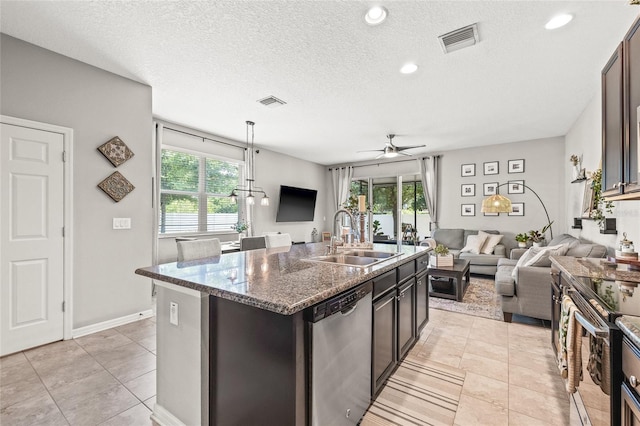 6974 Holly Heath Dr, Riverview, FL 33578 - kitchen with appliances with stainless steel finishes, a sink, open floor plan, plenty of natural light, and a textured ceiling
