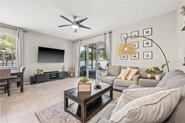 6974 Holly Heath Dr, Riverview, FL 33578 - living room with healthy amount of natural light, ceiling fan, a textured ceiling, and light tile patterned floors