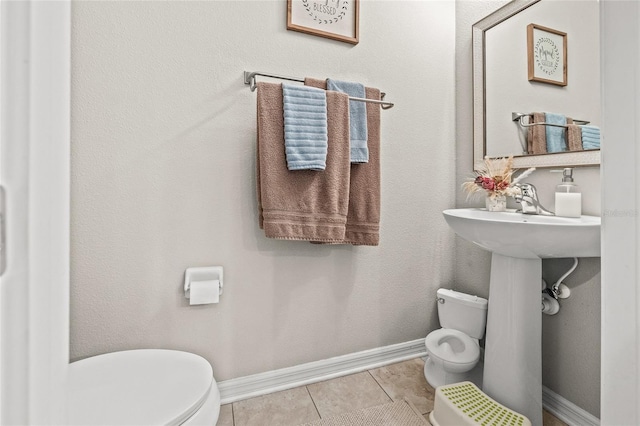 6974 Holly Heath Dr, Riverview, FL 33578 - bathroom with toilet, tile patterned flooring, and baseboards