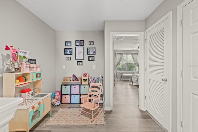 6974 Holly Heath Dr, Riverview, FL 33578 - recreation room featuring wood finished floors and baseboards
