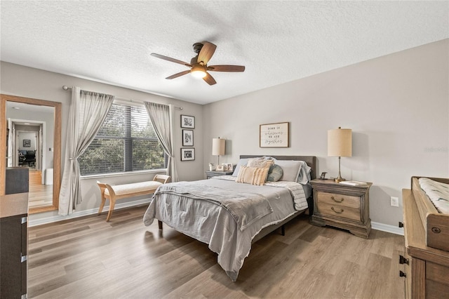 6974 Holly Heath Dr, Riverview, FL 33578 - bedroom featuring wood finished floors, baseboards, a textured ceiling, and ceiling fan