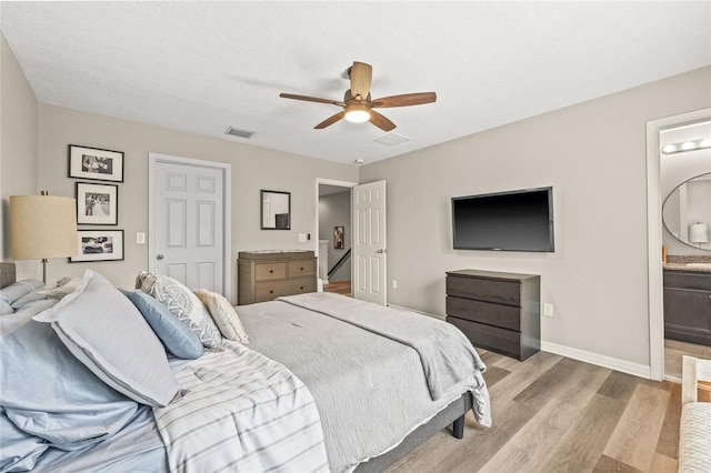 6974 Holly Heath Dr, Riverview, FL 33578 - bedroom with light wood-style flooring, baseboards, a ceiling fan, connected bathroom, and a closet