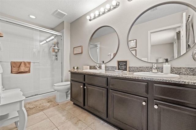 6974 Holly Heath Dr, Riverview, FL 33578 - full bath with toilet, a stall shower, double vanity, a textured ceiling, and tile patterned flooring