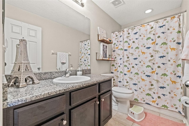 6974 Holly Heath Dr, Riverview, FL 33578 - full bathroom with tile patterned floors, toilet, vanity, and a textured ceiling