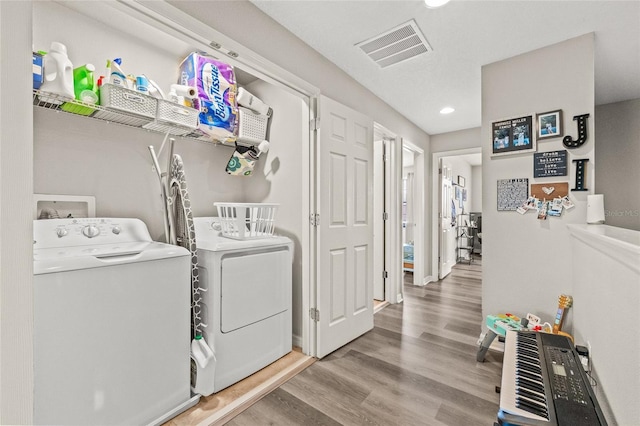 6974 Holly Heath Dr, Riverview, FL 33578 - washroom with washer and clothes dryer, wood finished floors, recessed lighting, and baseboards
