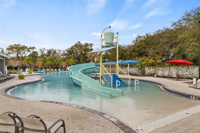 6974 Holly Heath Dr, Riverview, FL 33578 - community pool with a water slide, a patio area, and view of scattered trees