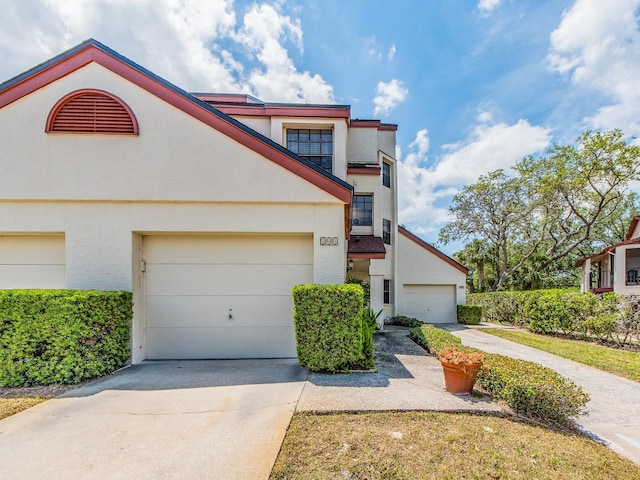3455 Countryside Blvd Unit 101, Clearwater, FL 33761 - multi unit property featuring driveway, stucco siding, and a garage