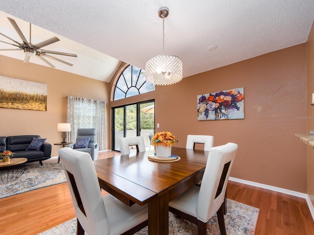 3455 Countryside Blvd Unit 101, Clearwater, FL 33761 - dining space featuring light wood-style flooring, vaulted ceiling, ceiling fan, baseboards, and a textured ceiling