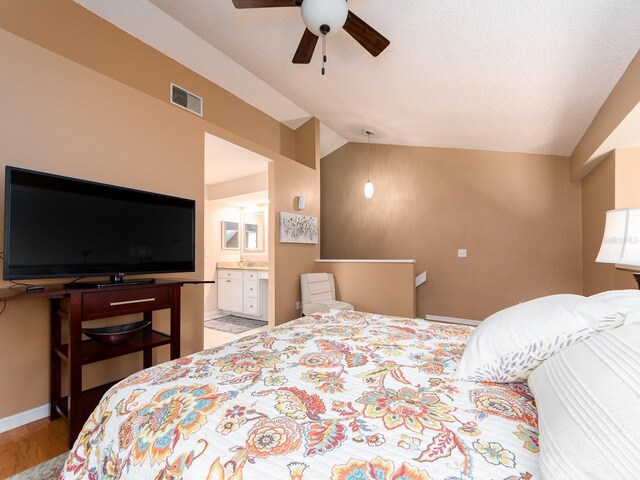 3455 Countryside Blvd Unit 101, Clearwater, FL 33761 - bedroom with lofted ceiling, wood finished floors, ensuite bath, baseboards, and ceiling fan