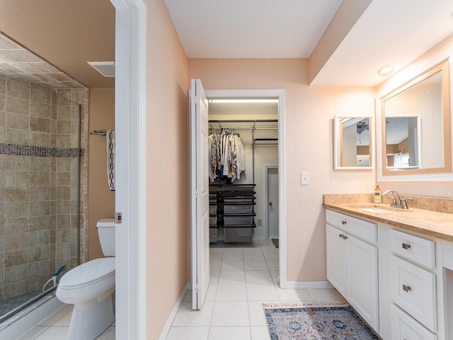 3455 Countryside Blvd Unit 101, Clearwater, FL 33761 - full bath with vanity, a spacious closet, a shower stall, toilet, and tile patterned flooring