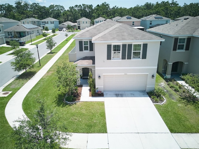 10826 Trailing Vine Dr, Tampa, FL 33610 - view of front of property with a garage, roof with shingles, a residential view, stucco siding, and concrete driveway