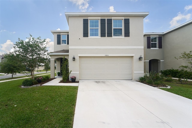 10826 Trailing Vine Dr, Tampa, FL 33610 - traditional-style house with stucco siding, driveway, an attached garage, and a front lawn