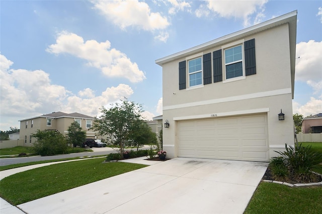 10826 Trailing Vine Dr, Tampa, FL 33610 - view of front facade with stucco siding, an attached garage, driveway, and a front yard