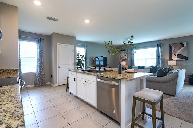 10826 Trailing Vine Dr, Tampa, FL 33610 - kitchen with dishwasher, a sink, open floor plan, light tile patterned floors, and white cabinets