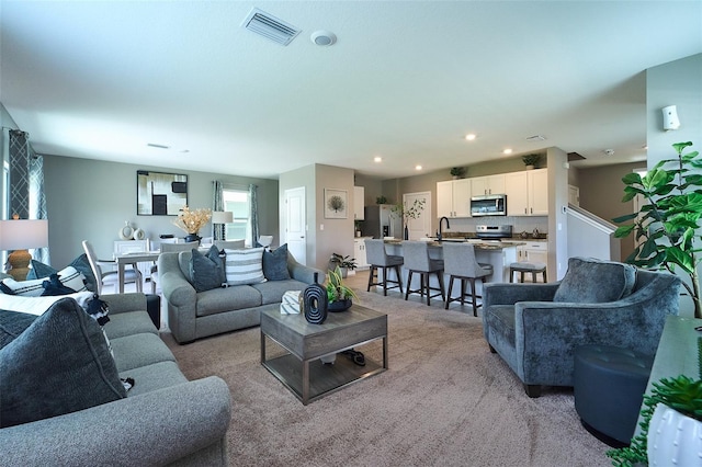 10826 Trailing Vine Dr, Tampa, FL 33610 - carpeted living room with a sink and recessed lighting