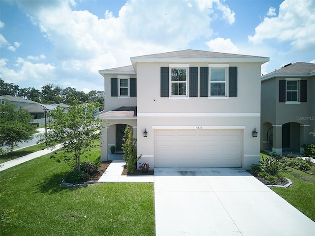 10826 Trailing Vine Dr, Tampa, FL 33610 - traditional-style home with driveway, a garage, stucco siding, and a front yard