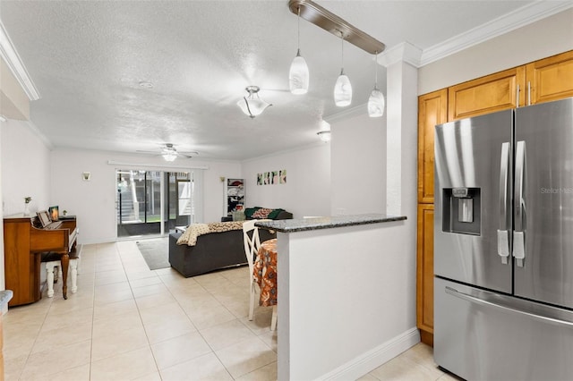 4032 Cortez Dr Unit A, Tampa, FL 33614 - kitchen with stainless steel fridge with ice dispenser, ornamental molding, ceiling fan, dark stone counters, and light tile patterned floors