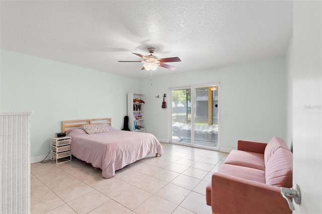 4032 Cortez Dr Unit A, Tampa, FL 33614 - bedroom featuring access to exterior, light tile patterned flooring, ceiling fan, baseboards, and a textured ceiling