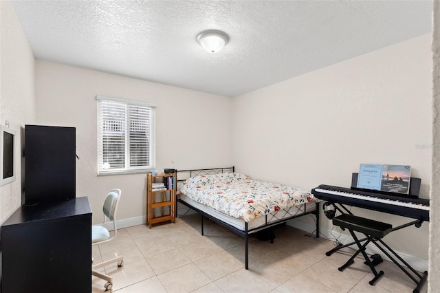 4032 Cortez Dr Unit A, Tampa, FL 33614 - bedroom featuring a textured ceiling, baseboards, and light tile patterned floors