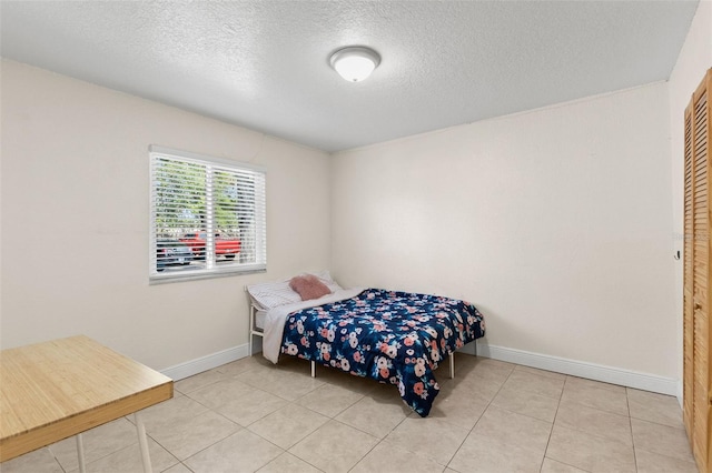 4032 Cortez Dr Unit A, Tampa, FL 33614 - tiled bedroom featuring a textured ceiling and baseboards