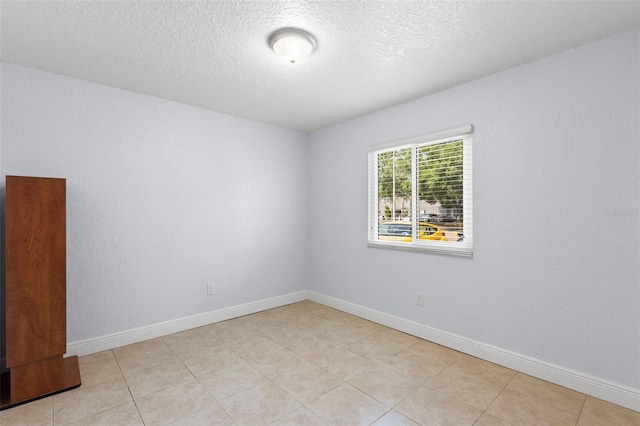 4032 Cortez Dr Unit A, Tampa, FL 33614 - empty room featuring a textured ceiling, baseboards, and light tile patterned flooring
