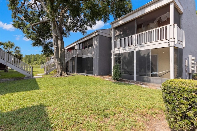 4032 Cortez Dr Unit A, Tampa, FL 33614 - view of grassy yard with stairs and a sunroom