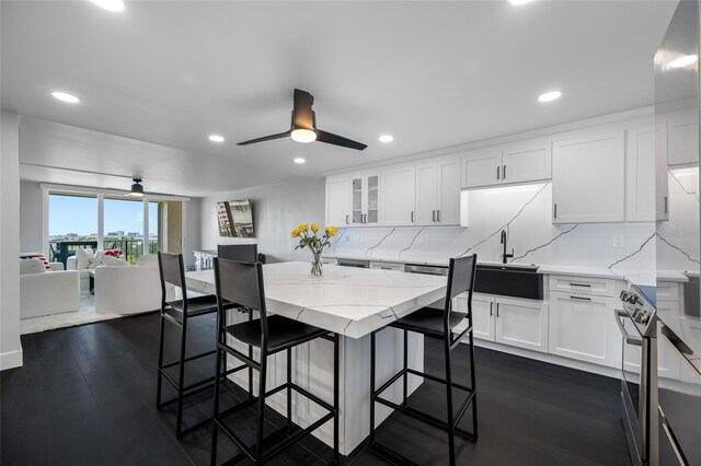 100 Oakmont Ln Unit 802, Belleair, FL 33756 - kitchen with a sink, backsplash, a kitchen bar, light stone countertops, and recessed lighting