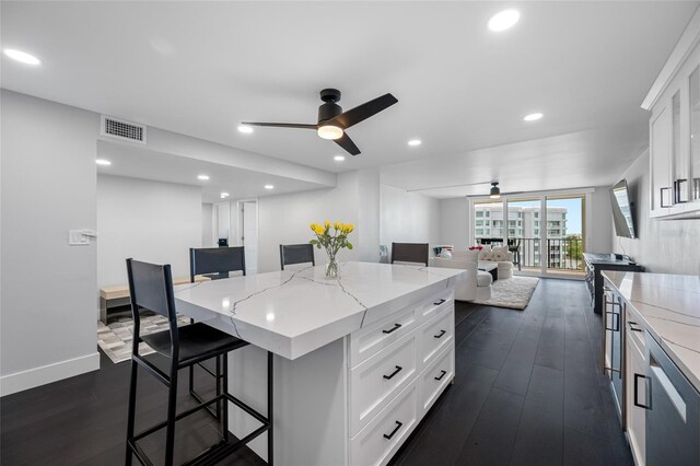 100 Oakmont Ln Unit 802, Belleair, FL 33756 - kitchen featuring ceiling fan, a breakfast bar, a center island, white cabinets, and dark wood finished floors