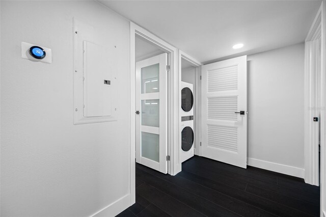 100 Oakmont Ln Unit 802, Belleair, FL 33756 - laundry room featuring stacked washer / drying machine, baseboards, electric panel, and dark wood-type flooring