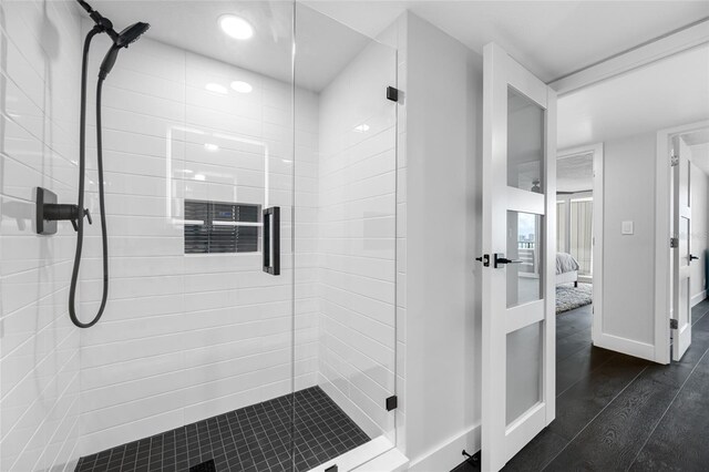 100 Oakmont Ln Unit 802, Belleair, FL 33756 - bathroom with a shower stall, ensuite bath, wood finished floors, and baseboards