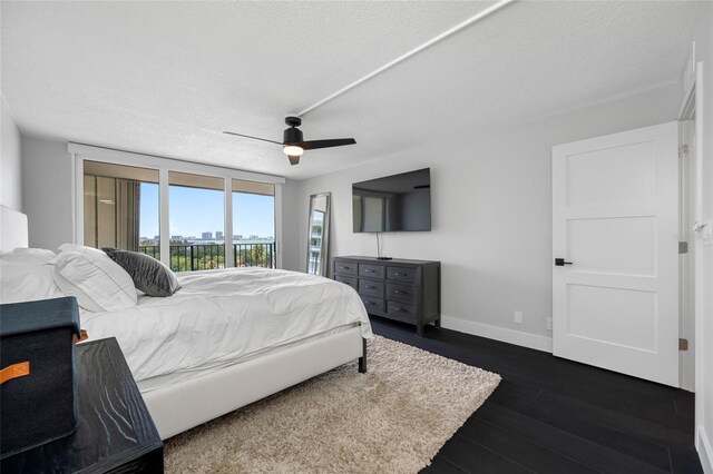 100 Oakmont Ln Unit 802, Belleair, FL 33756 - bedroom with access to exterior, baseboards, dark wood-style flooring, a textured ceiling, and a ceiling fan