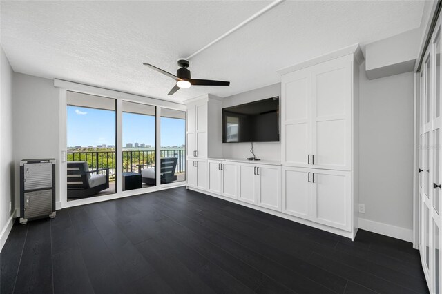 100 Oakmont Ln Unit 802, Belleair, FL 33756 - unfurnished living room featuring baseboards, a ceiling fan, dark wood-style floors, floor to ceiling windows, and a textured ceiling