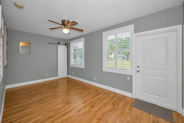 2073 Denmark St Unit 9, Clearwater, FL 33763 - spare room featuring light wood finished floors, ceiling fan, a textured ceiling, baseboards, and a smoke detector