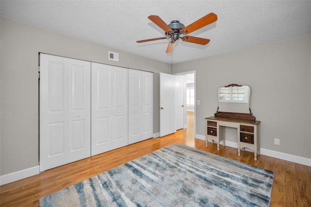 2073 Denmark St Unit 9, Clearwater, FL 33763 - bedroom featuring baseboards, wood finished floors, a closet, and a ceiling fan