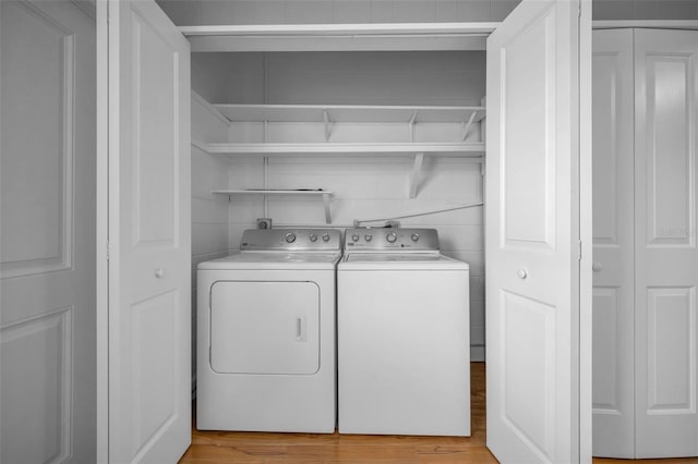 2073 Denmark St Unit 9, Clearwater, FL 33763 - laundry area with washing machine and dryer and light wood-style flooring