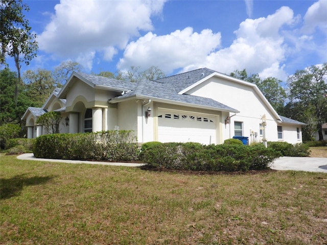 12271 Centralia Rd, Weeki Wachee, FL 34614 - view of side of property with stucco siding, a garage, a yard, and a shingled roof
