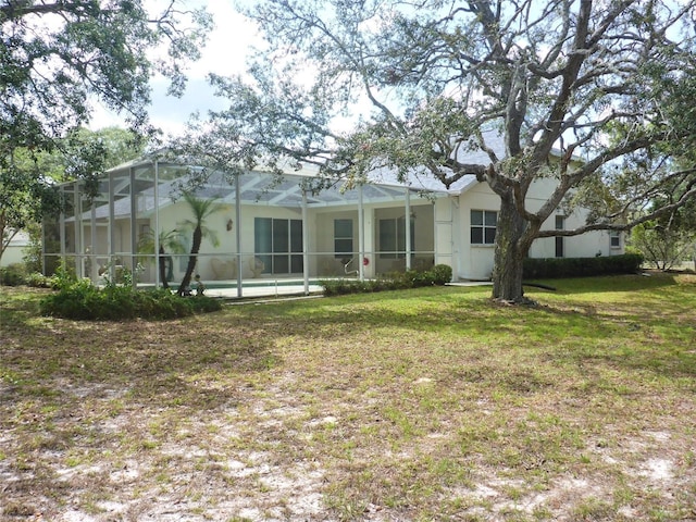 12271 Centralia Rd, Weeki Wachee, FL 34614 - back of property featuring a yard, glass enclosure, and an outdoor pool