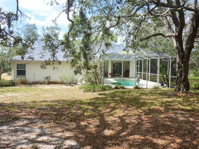 12271 Centralia Rd, Weeki Wachee, FL 34614 - rear view of house featuring stucco siding, an outdoor pool, and a lanai