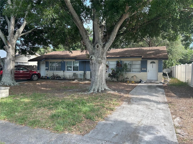 560 73rd Ave N, Saint Petersburg, FL 33702 - view of front of house with concrete block siding and a shingled roof