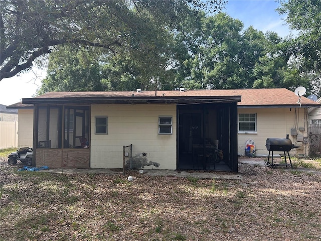 560 73rd Ave N, Saint Petersburg, FL 33702 - rear view of property with a sunroom and a shingled roof
