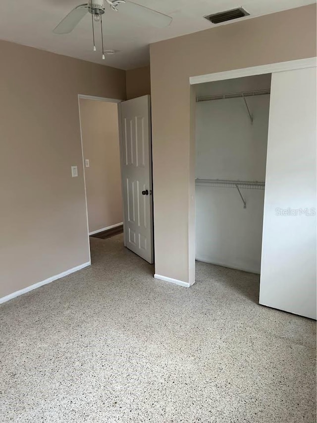 560 73rd Ave N, Saint Petersburg, FL 33702 - unfurnished bedroom with a closet, speckled floor, baseboards, and a ceiling fan