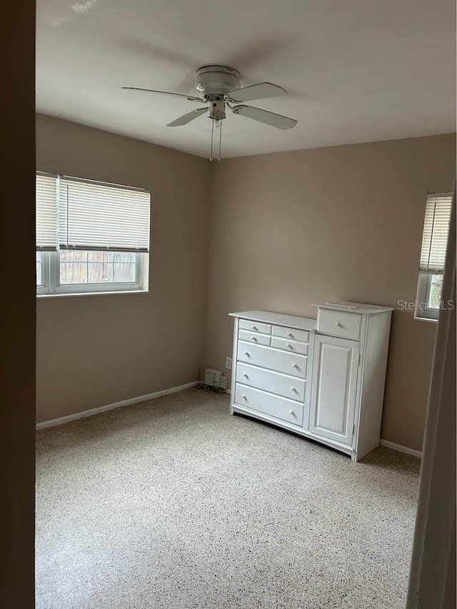 560 73rd Ave N, Saint Petersburg, FL 33702 - unfurnished bedroom with baseboards, a ceiling fan, and light carpet
