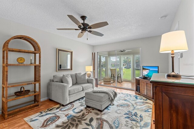1701 Pinehurst Rd Unit 9G, Dunedin, FL 34698 - living area featuring a ceiling fan, a textured ceiling, and wood finished floors