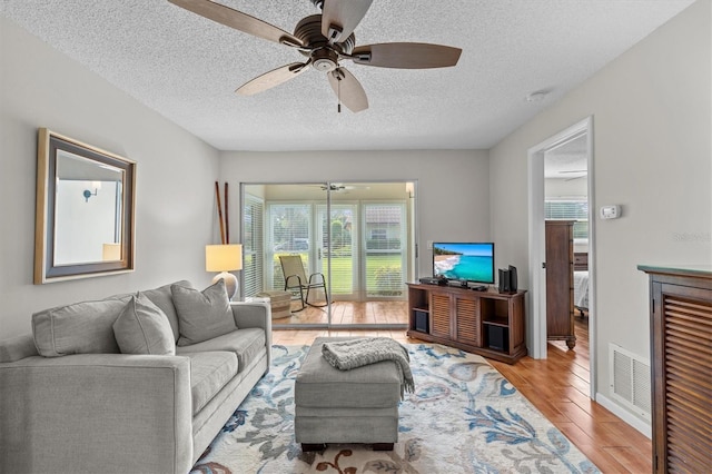 1701 Pinehurst Rd Unit 9G, Dunedin, FL 34698 - living area with a ceiling fan, wood finished floors, and a textured ceiling