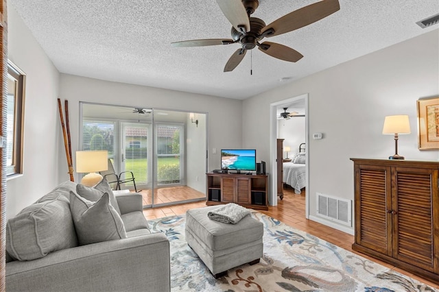1701 Pinehurst Rd Unit 9G, Dunedin, FL 34698 - living room with ceiling fan, a textured ceiling, and wood finished floors