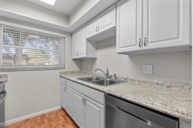 1701 Pinehurst Rd Unit 9G, Dunedin, FL 34698 - kitchen featuring stainless steel dishwasher, a sink, light wood-style flooring, and light countertops