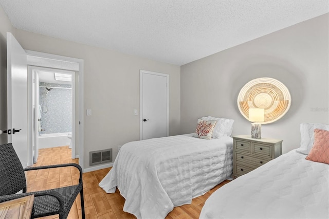 1701 Pinehurst Rd Unit 9G, Dunedin, FL 34698 - bedroom with wood finished floors, a textured ceiling, and baseboards
