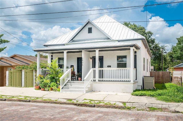 2406 E Clark St, Tampa, FL 33605 - view of front facade featuring stucco siding, a porch, a standing seam roof, and metal roof